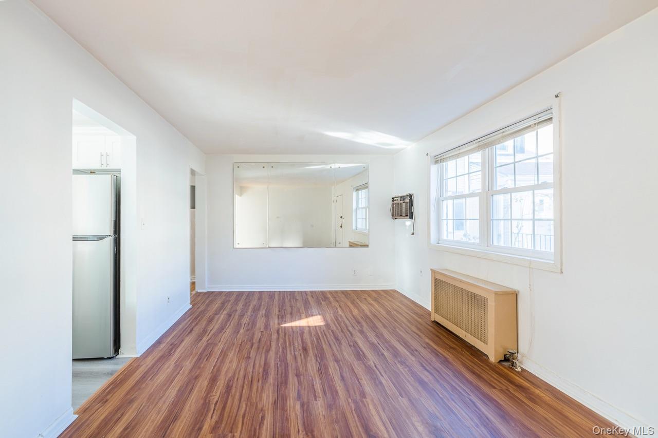 222-17 69th Avenue, Unit 17A Queens, NY 11364 - Photo 6 of 10 a view of empty room with wooden floor and fan