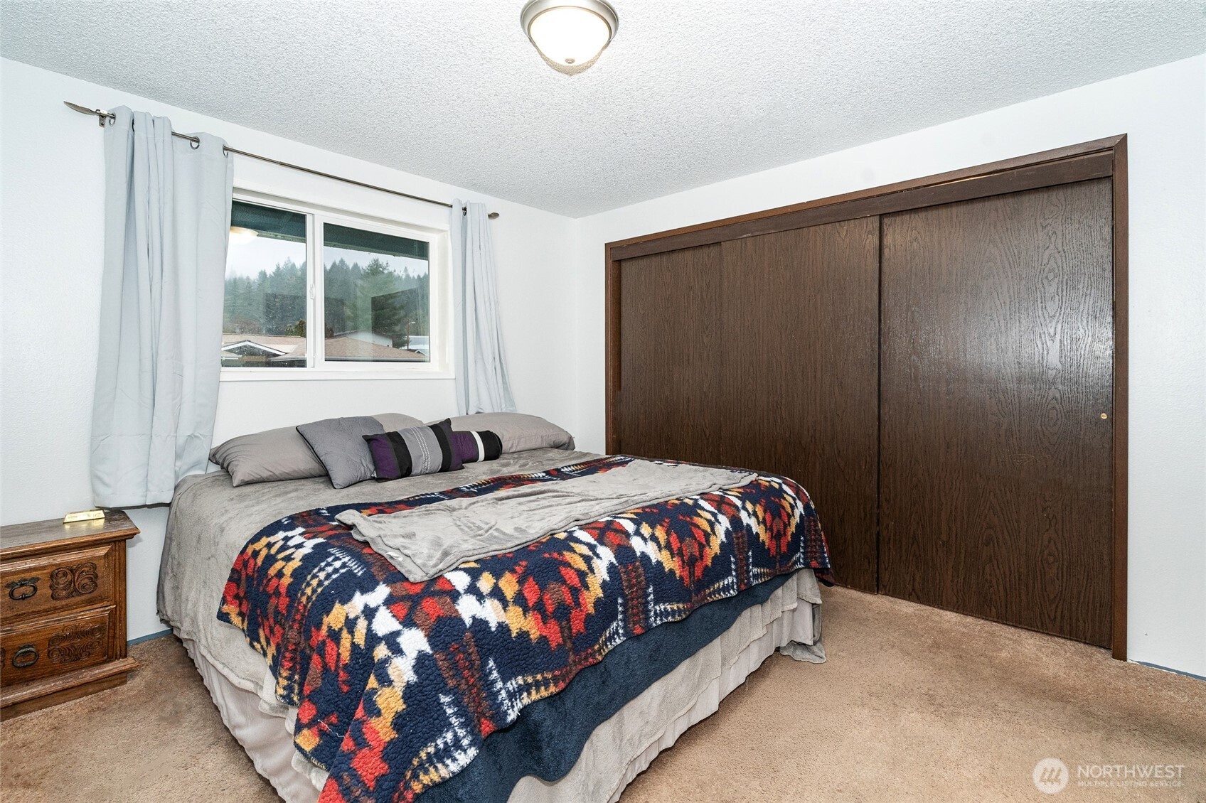 2119 Southwest Olympic Drive Chehalis, WA 98532 - Photo 17 of 33 a bed sitting in a bedroom next to a window