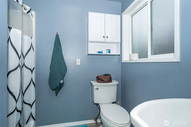 a white toilet sitting next to a bathroom sink