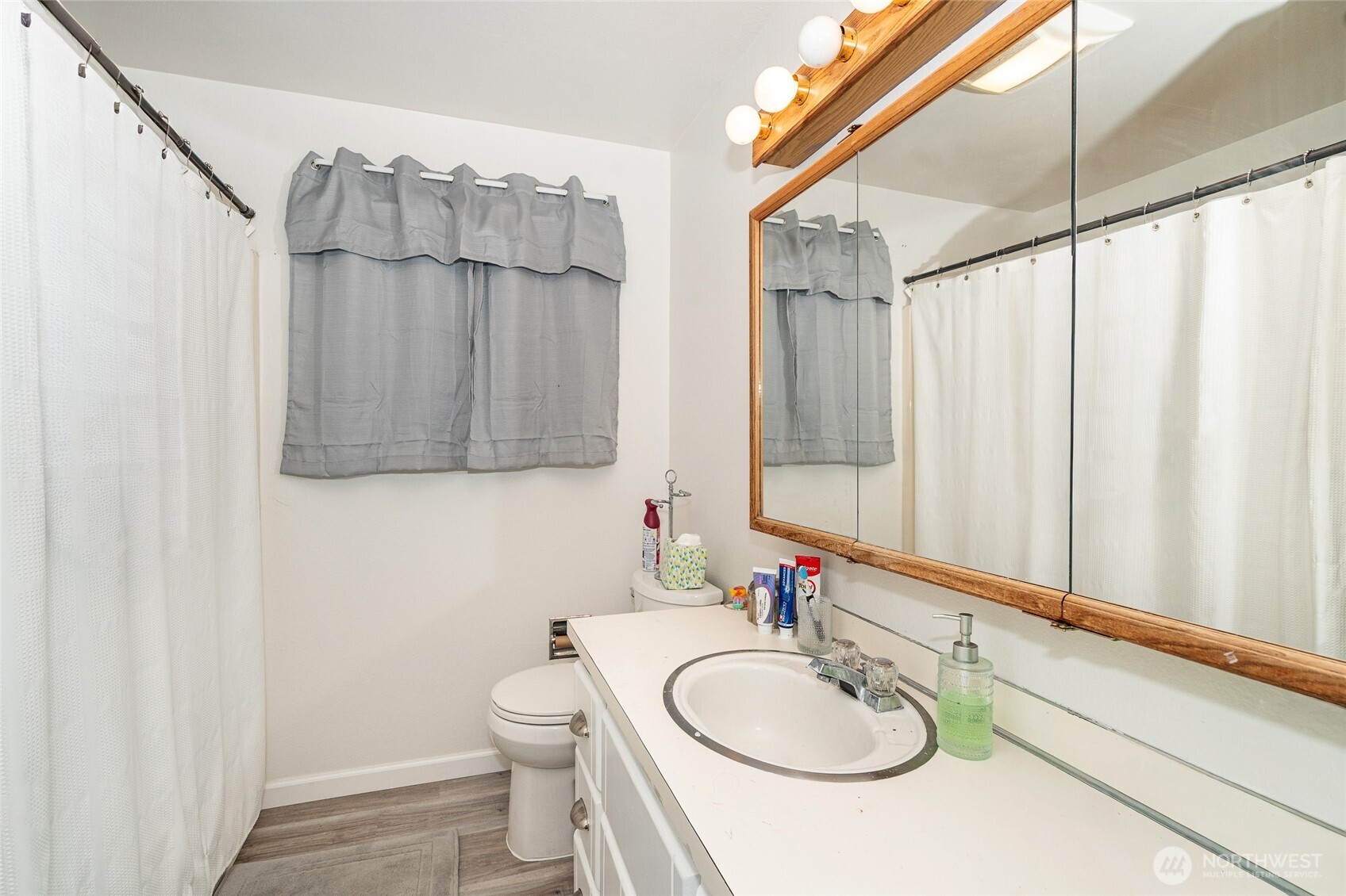 2119 Southwest Olympic Drive Chehalis, WA 98532 - Photo 21 of 33 a bathroom with a sink a toilet and shower curtain
