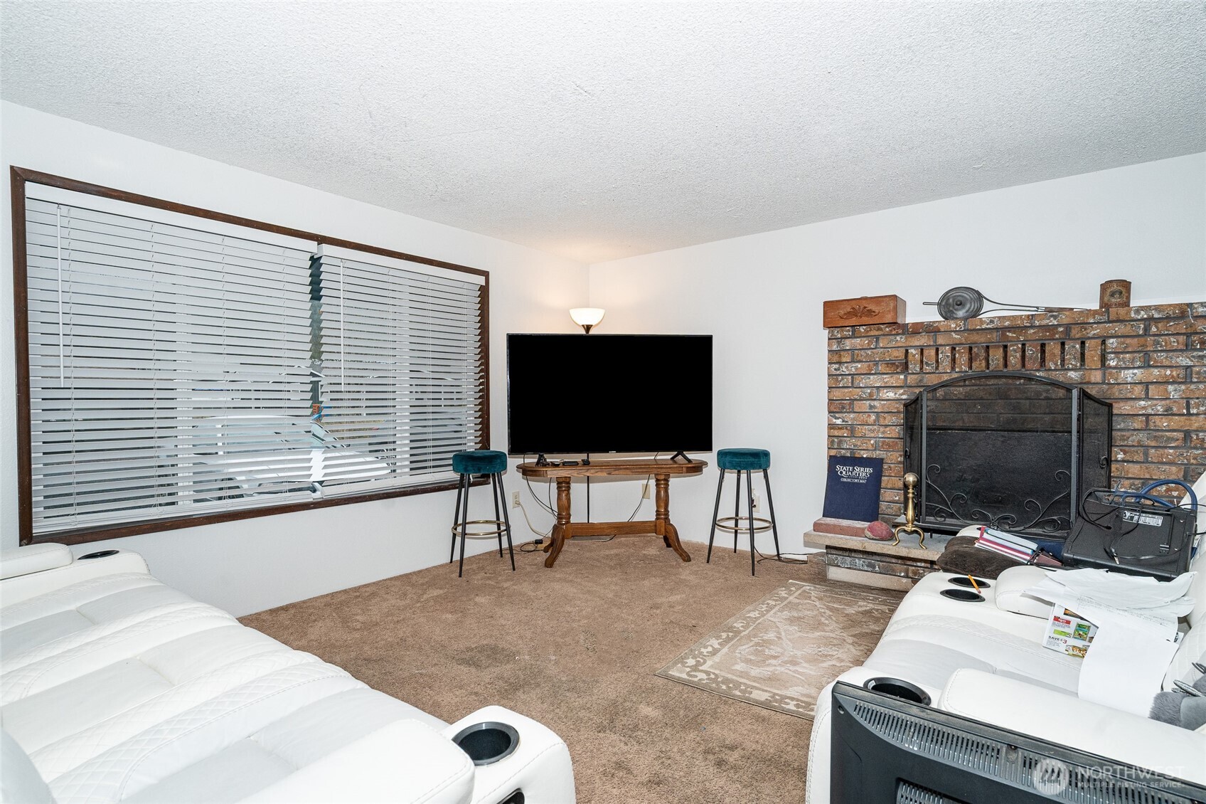 2119 Southwest Olympic Drive Chehalis, WA 98532 - Photo 4 of 33 a living room with furniture a flat screen tv and a fireplace