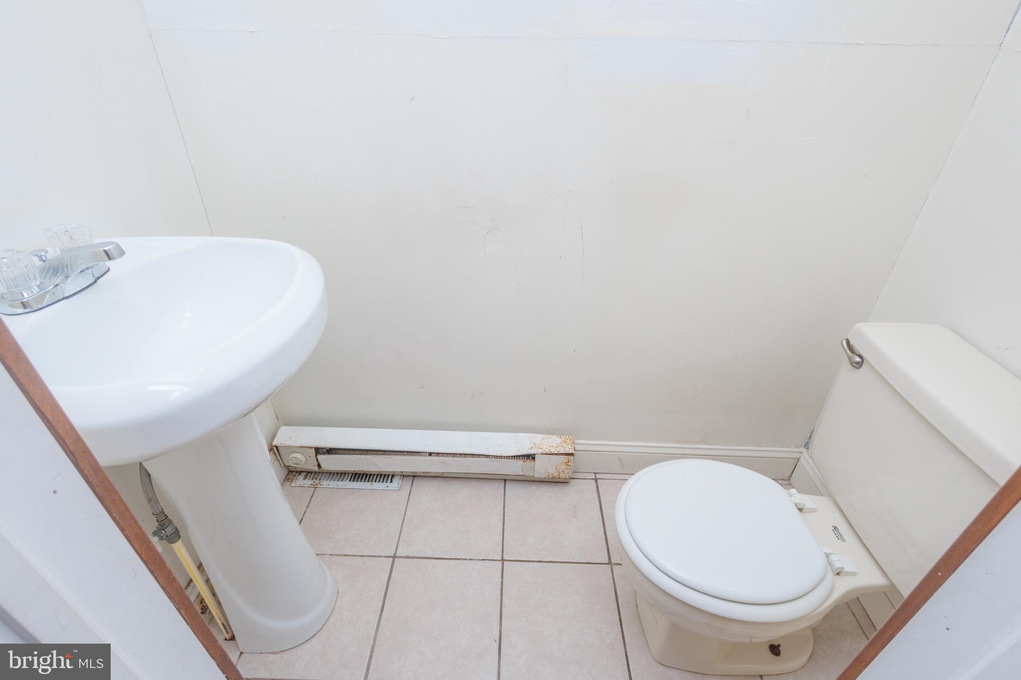 130 State Street Glassboro, NJ 08028 - Photo 10 of 17 a white toilet sitting next to a white sink