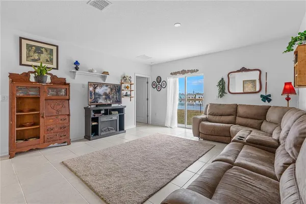 a living room with furniture and dresser