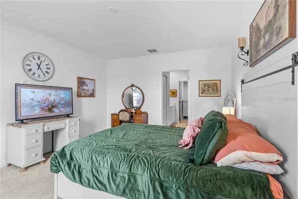 a bed sitting in a bedroom next to a window