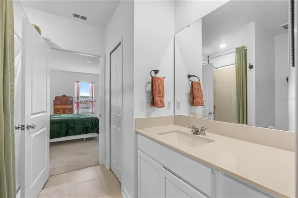 a en suite bathroom with a sink and mirror