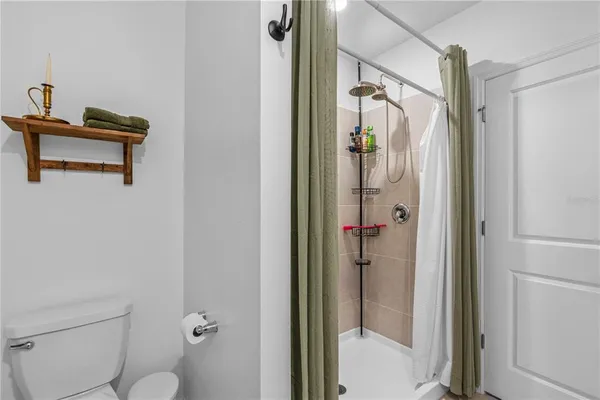 a bathroom with a shower and a toilet