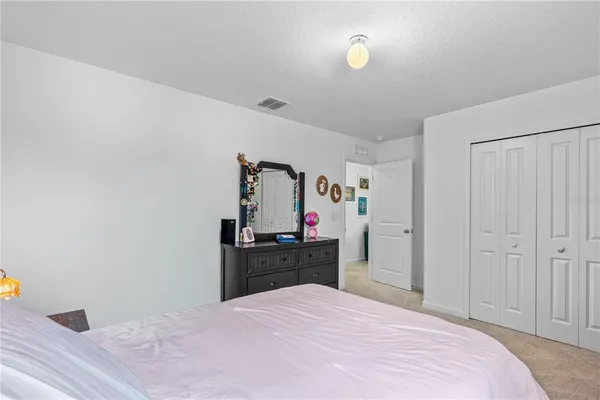 a bed room with a bed and closet