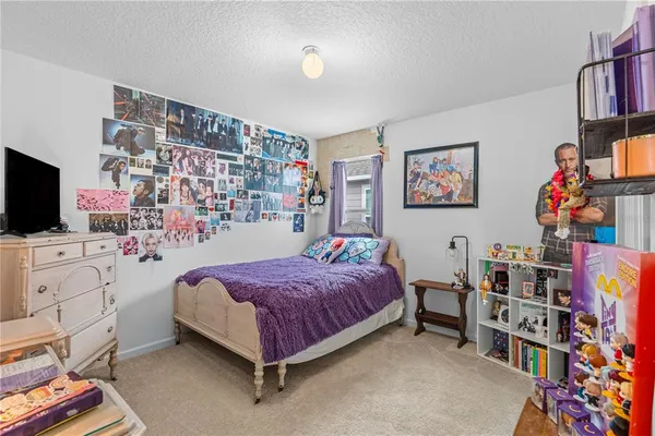 a bedroom with a bed furniture and a flat screen tv