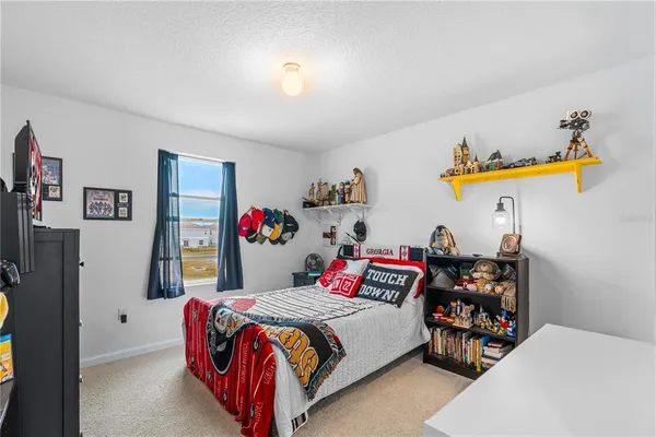 a bedroom with bed and a chandelier
