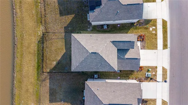 an aerial view of a house with a yard