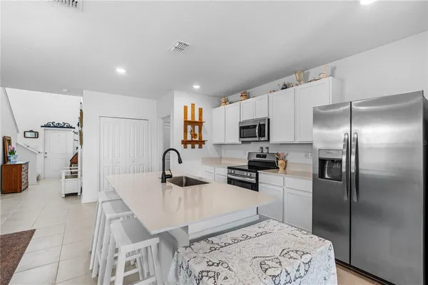 a kitchen with stainless steel appliances a refrigerator sink microwave and cabinets