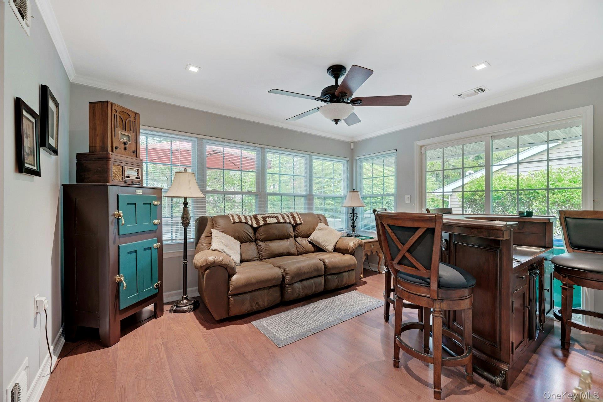 104 Glen Drive Ridge, NY 11961 - Photo 8 of 25 a living room with furniture a ceiling fan and a large window