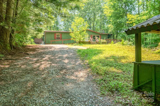 a view of an house with backyard space and balcony