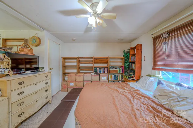 a bedroom with furniture and a flat screen tv