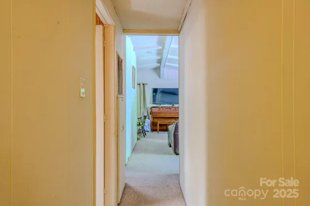 a view of a hallway with a room and a window