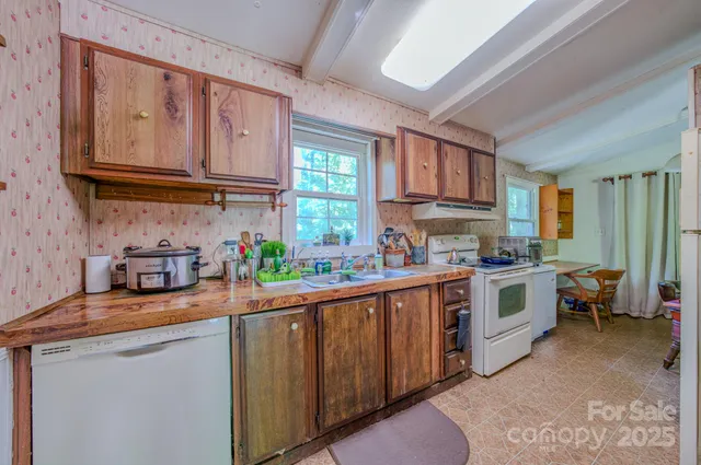 a kitchen with stainless steel appliances a sink stove and cabinets