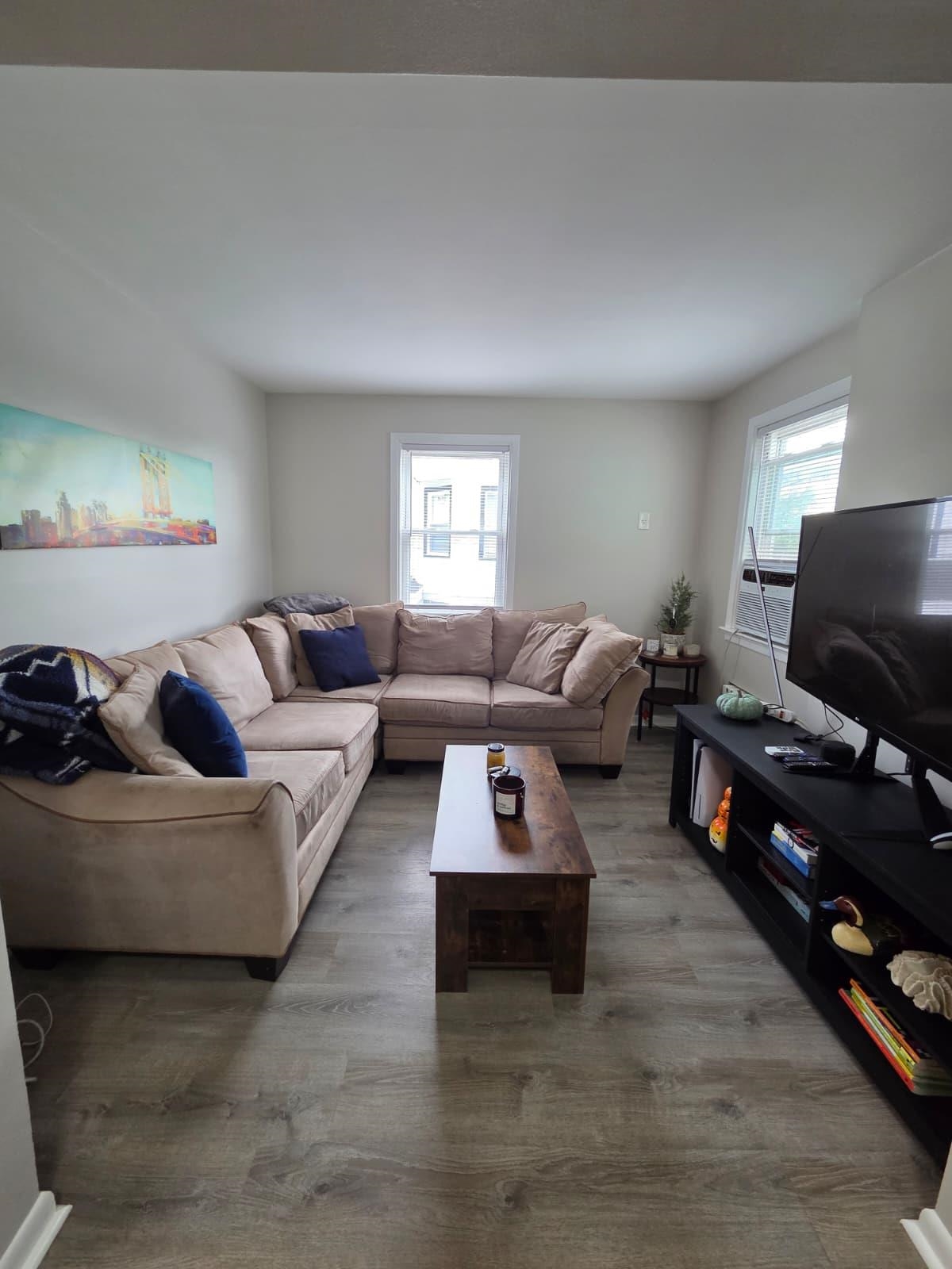 166 Carmita Avenue, Unit 2 Rutherford, NJ 07070 - Photo 5 of 27 a living room with furniture and wooden floor