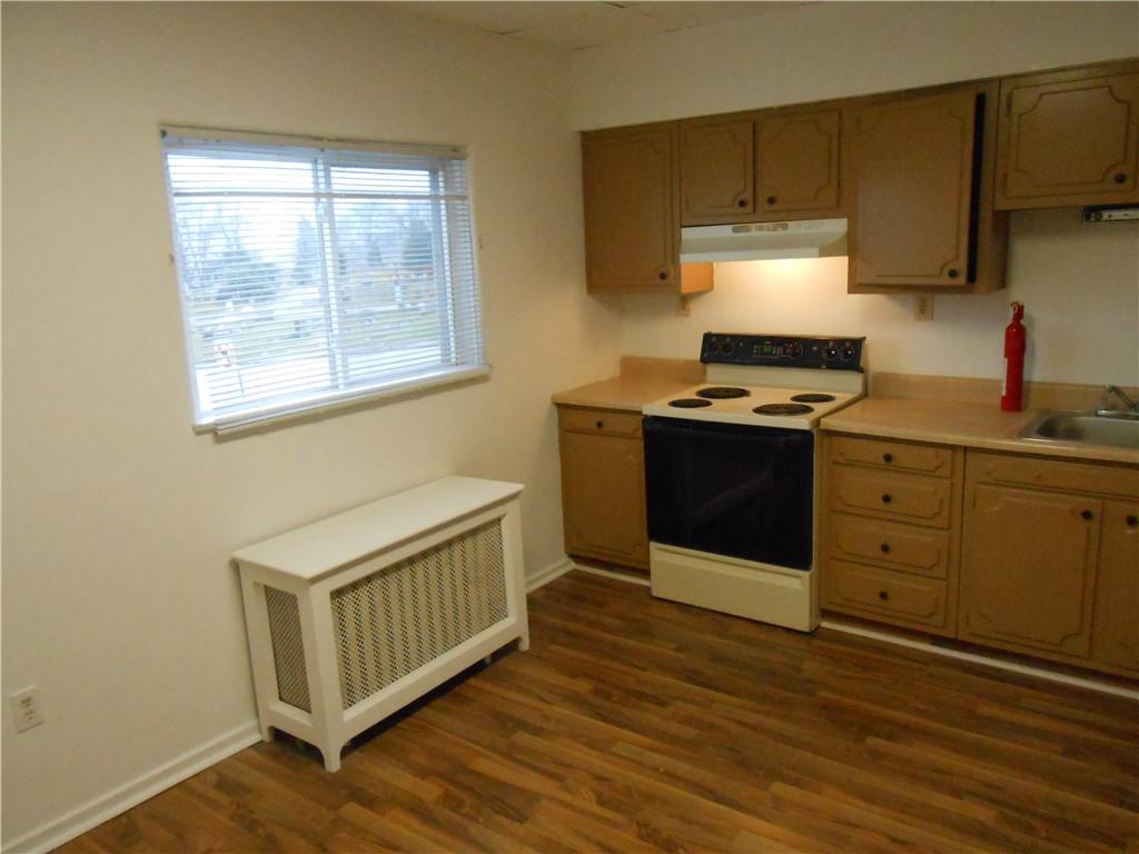 219 5th Street, Unit 1 Dravosburg, PA 15034 - Photo 12 of 16 a kitchen with stainless steel appliances granite countertop a stove a sink and a refrigerator
