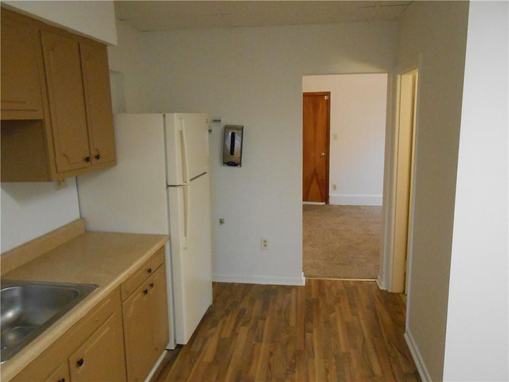 219 5th Street, Unit 1 Dravosburg, PA 15034 - Photo 13 of 16 a view of a kitchen with a sink and refrigerator