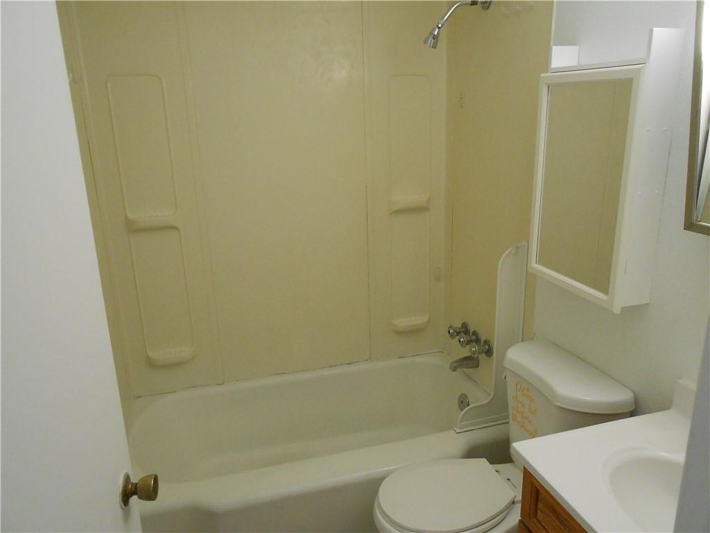 219 5th Street, Unit 1 Dravosburg, PA 15034 - Photo 14 of 16 a white toilet sitting next to a bath tub