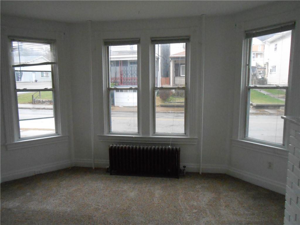 219 5th Street, Unit 1 Dravosburg, PA 15034 - Photo 5 of 16 an empty room with windows