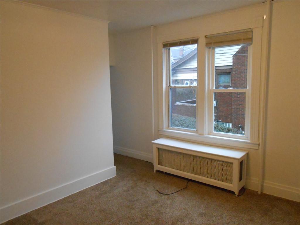 219 5th Street, Unit 1 Dravosburg, PA 15034 - Photo 10 of 16 a room with a bed and a window