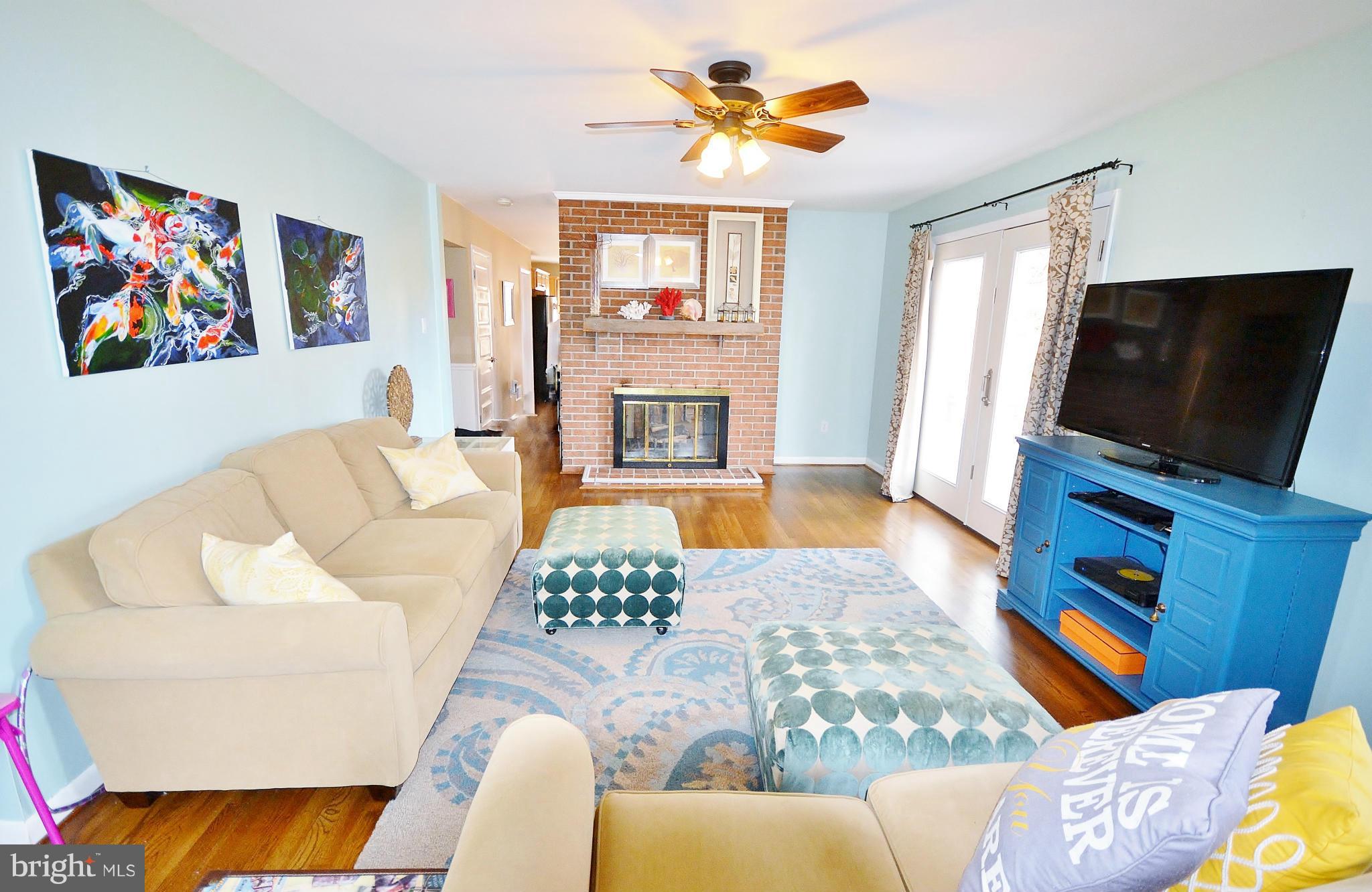 5070 Shaffer Mill Road Manchester, MD 21102 - Photo 16 of 30 a living room with furniture a fireplace and a flat screen tv