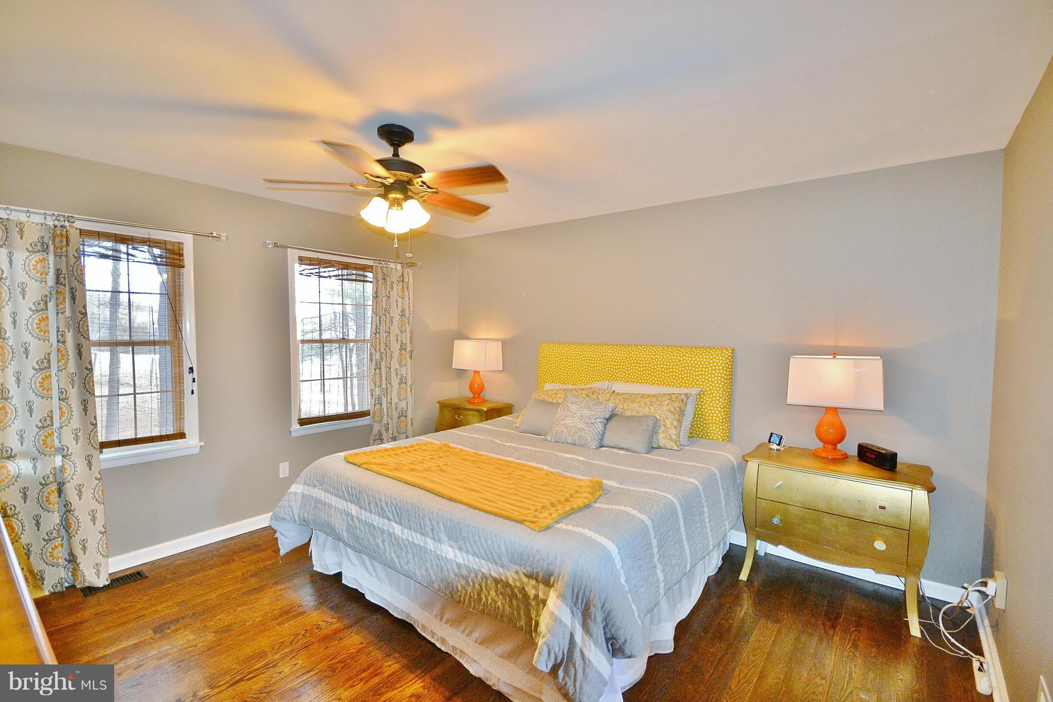 5070 Shaffer Mill Road Manchester, MD 21102 - Photo 5 of 30 a bedroom with a bed and wooden floor