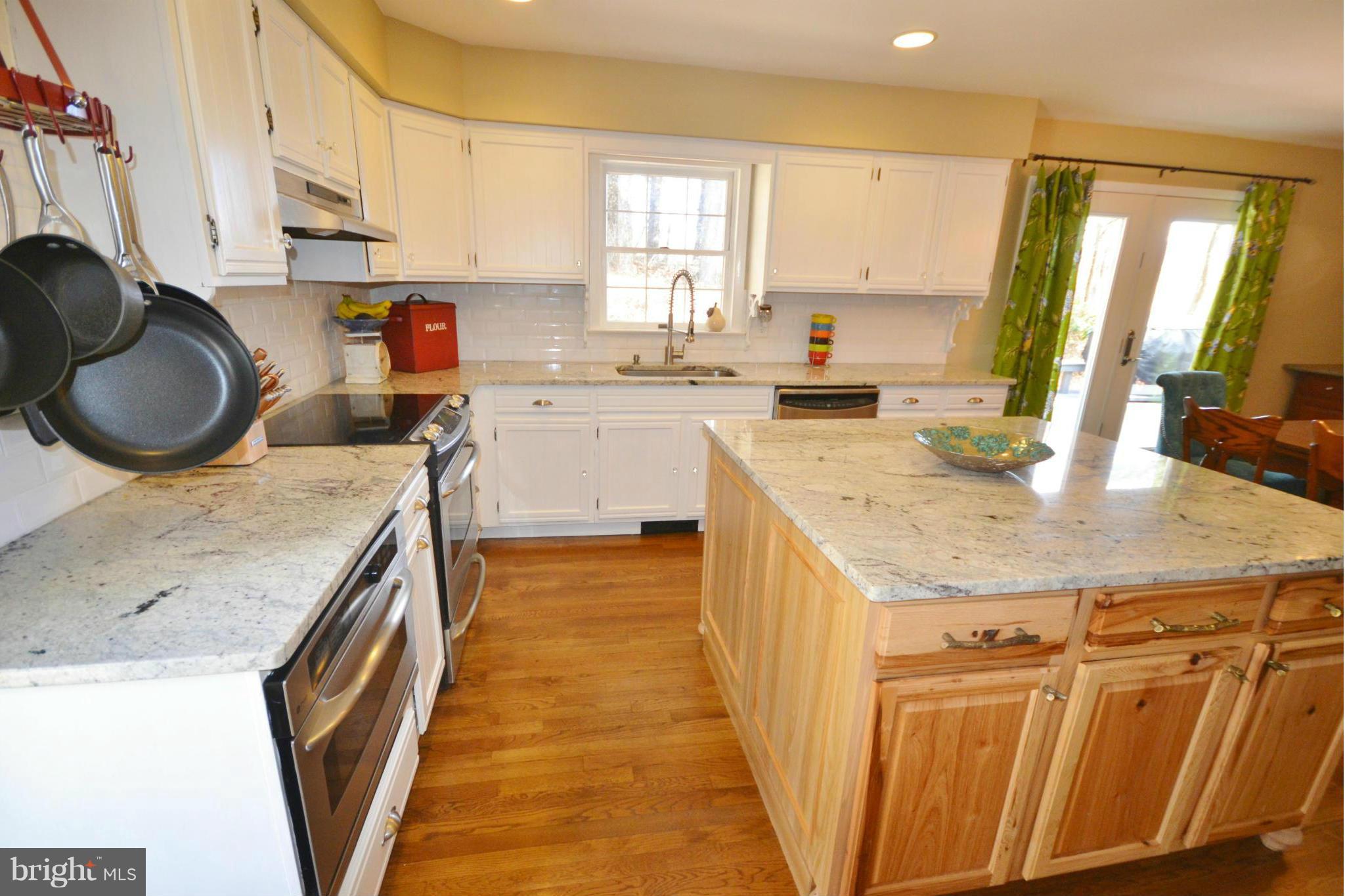 5070 Shaffer Mill Road Manchester, MD 21102 - Photo 7 of 30 a kitchen with a sink a stove a refrigerator and cabinets