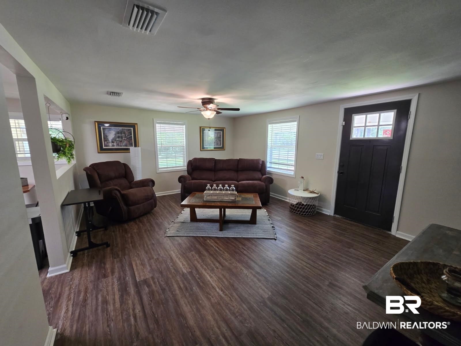 2534 Foshee Road Brewton, AL 36426 - Photo 12 of 16 Living room with baseboards, wood finished floors, and visible vents