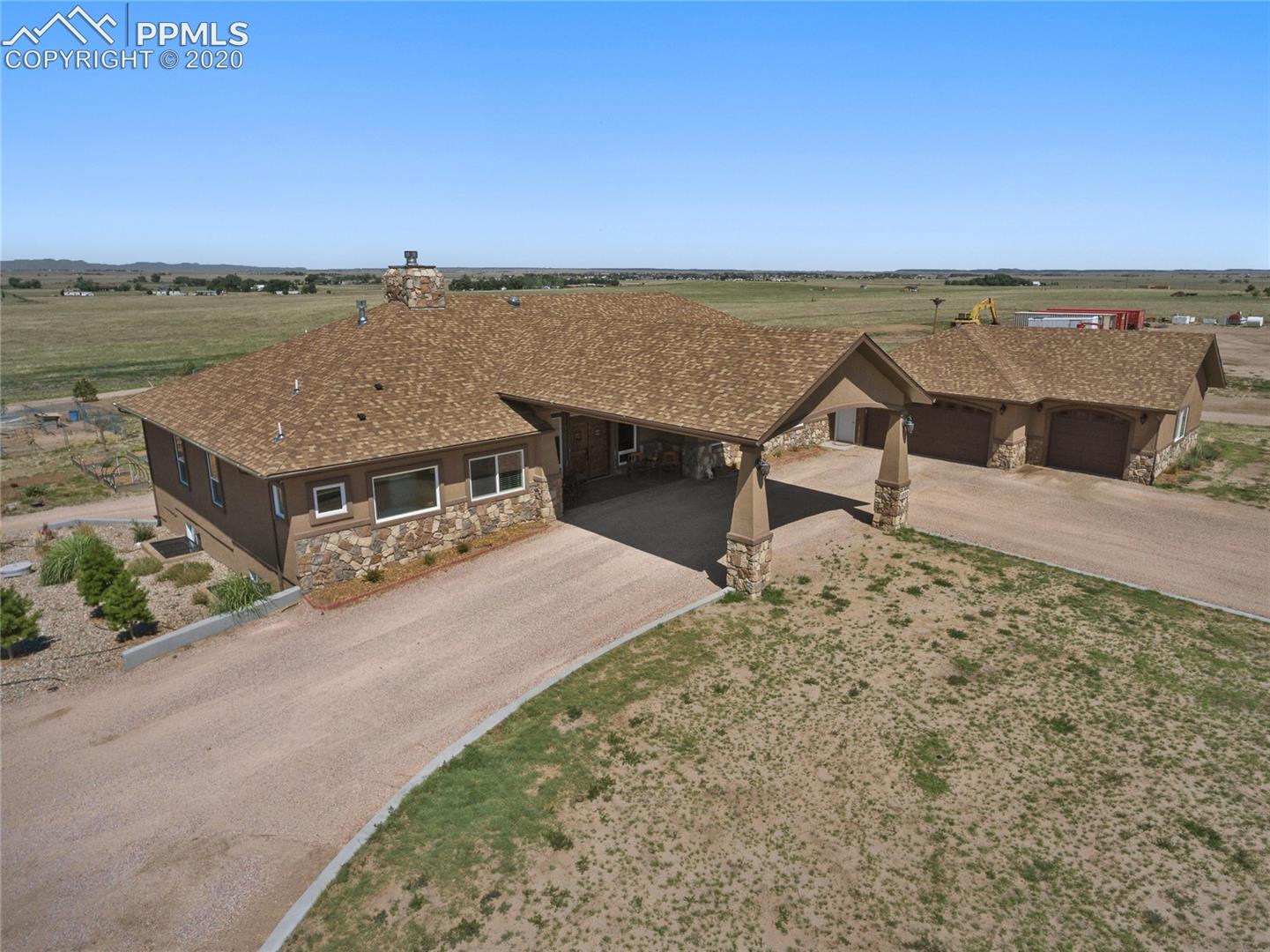 5930 North Log Road Peyton, CO 80831 - Photo 5 of 40 Attached garage- 1,220sf Insulated and drywalled, 2 OH doors, 2 walk-through doors including rear access door, garage door openers