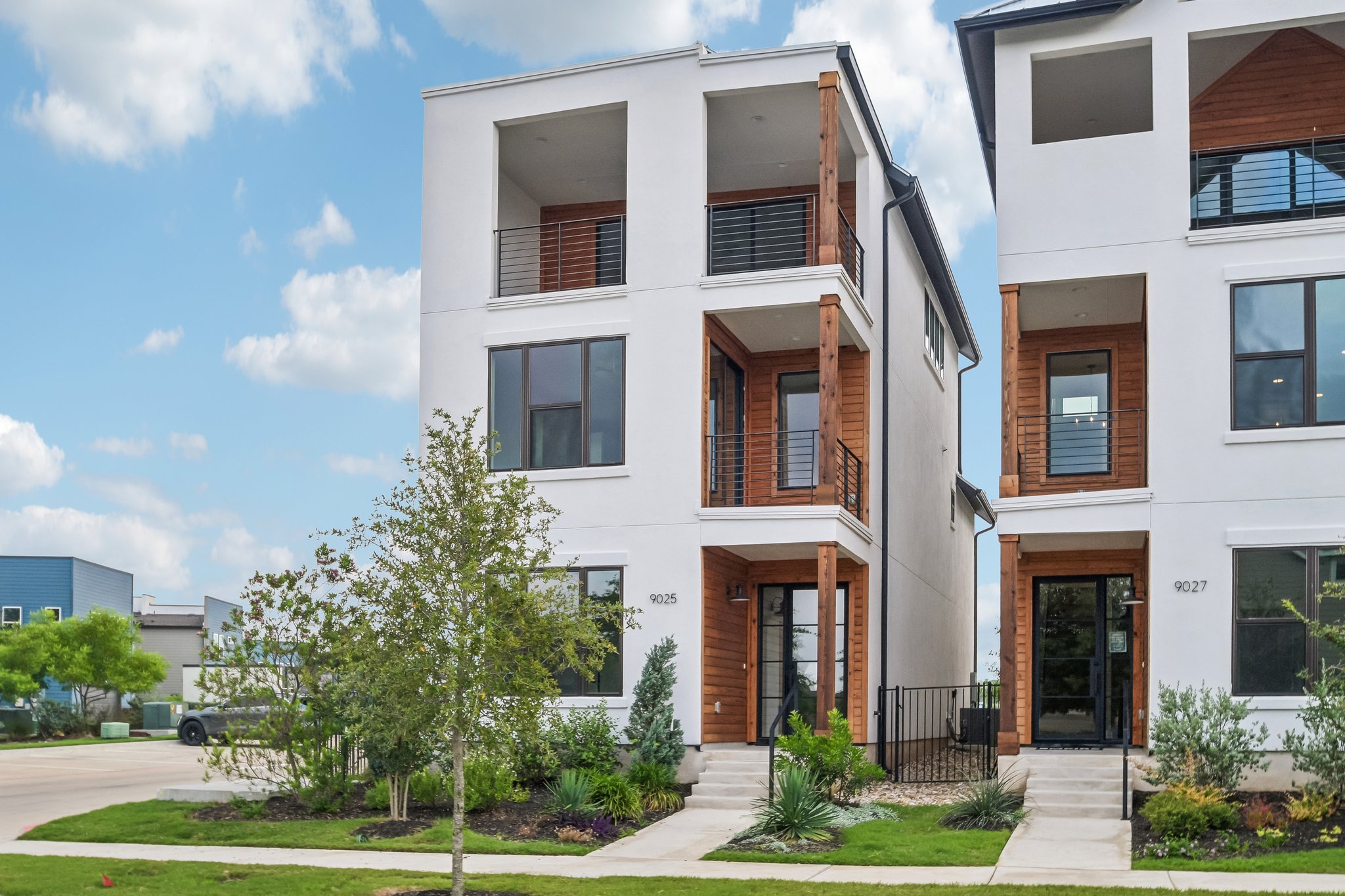 Modern townhomes boast individual balconies and a clean, vertical design.