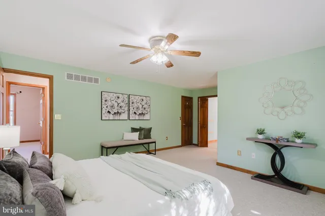 a bedroom with bed and a chandelier
