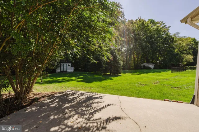 a view of a house with a yard and a garden