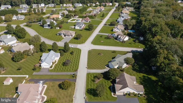 an aerial view of a house with a garden and yard