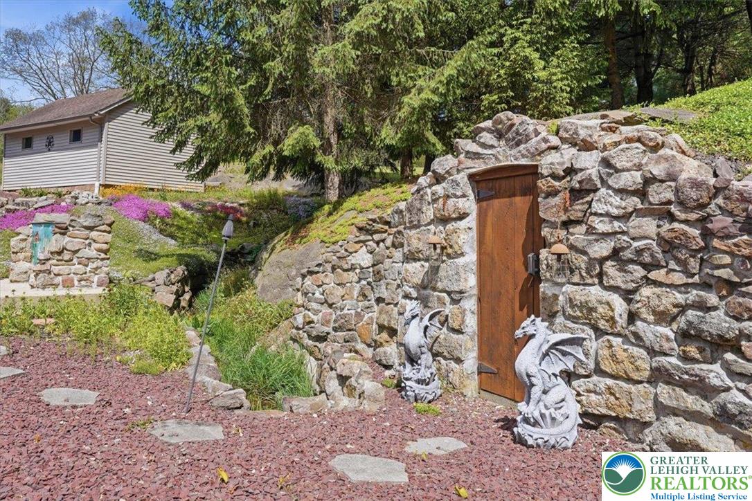 4880 Little Gap Road Kunkletown, PA 18058 - Photo 73 of 100 This charming outdoor area features a unique stone structure with a wooden door.