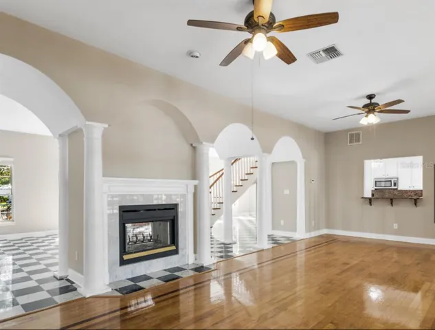 a view of a livingroom with a fireplace and fan