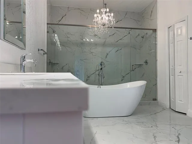 a bathroom with a bathtub and shower