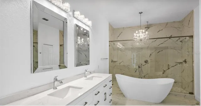 a bathroom with a bathtub shower sink and mirror