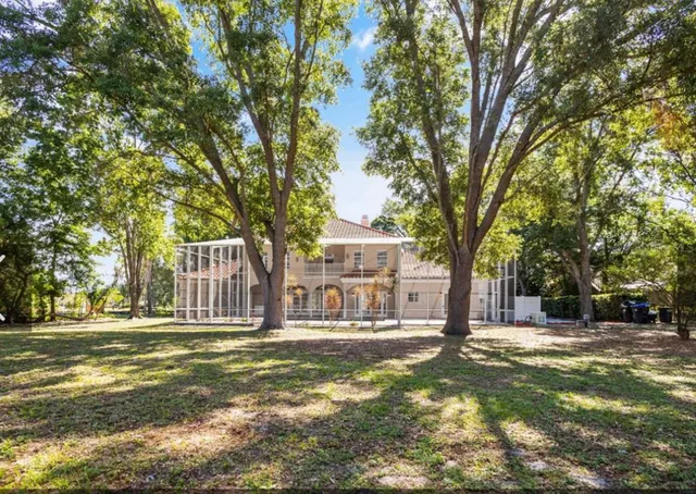 a front view of a building with a yard