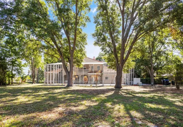 a view of a house with a large tree