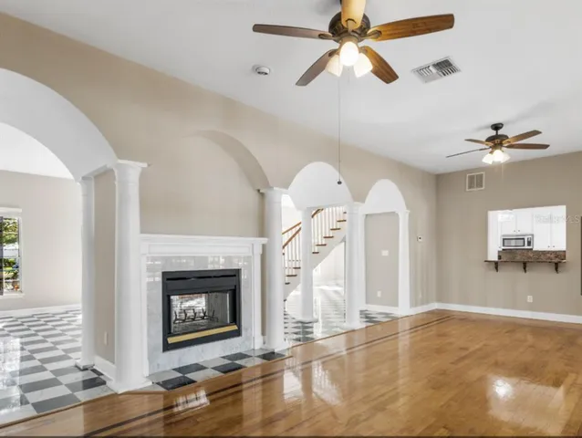 a view of a livingroom with a fireplace and fan
