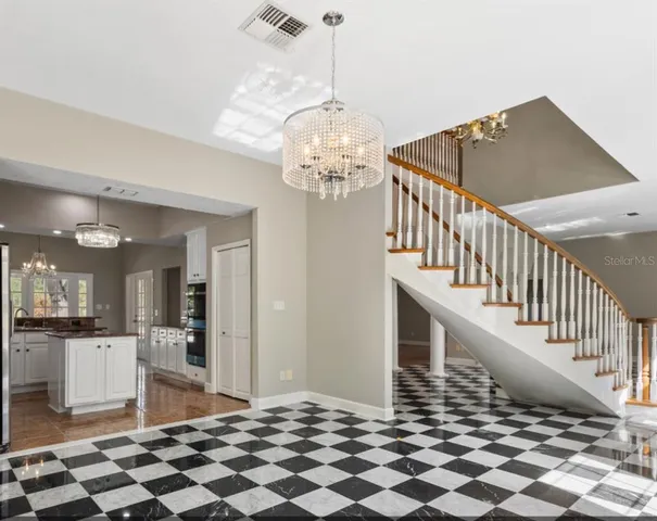 a dining room with furniture and chandelier