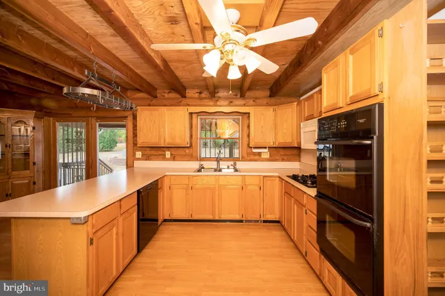 a kitchen with a stove a sink and a microwave