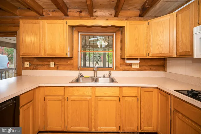 a kitchen with stainless steel appliances granite countertop a sink and cabinets