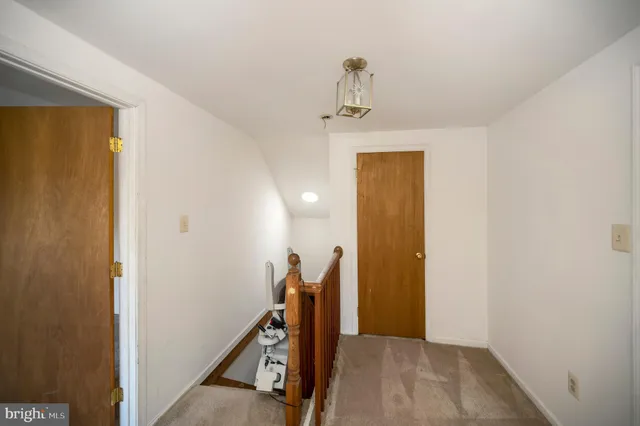 a view of a house with a wooden fence