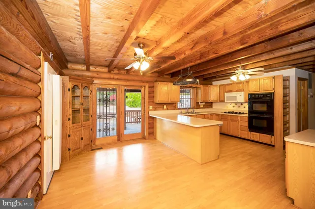 a kitchen with stainless steel appliances granite countertop a sink and cabinets