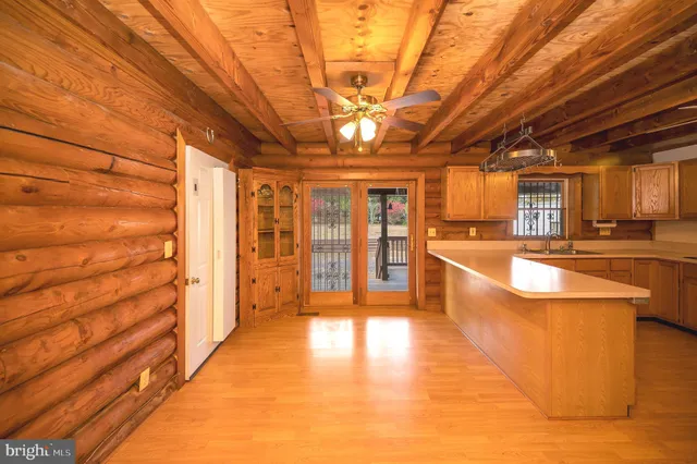 a large kitchen with stainless steel appliances granite countertop a stove and cabinets