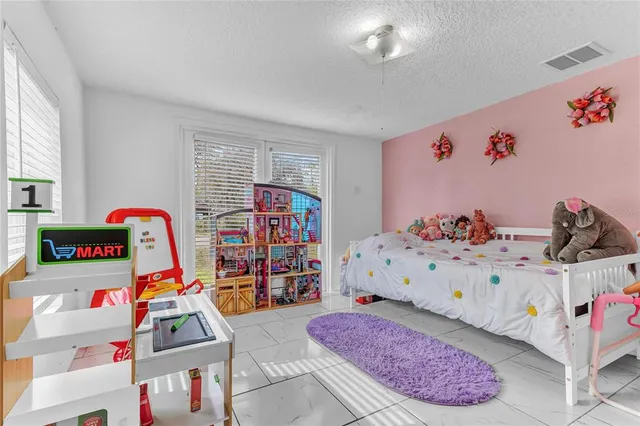 a bedroom with baby bed and a dresser