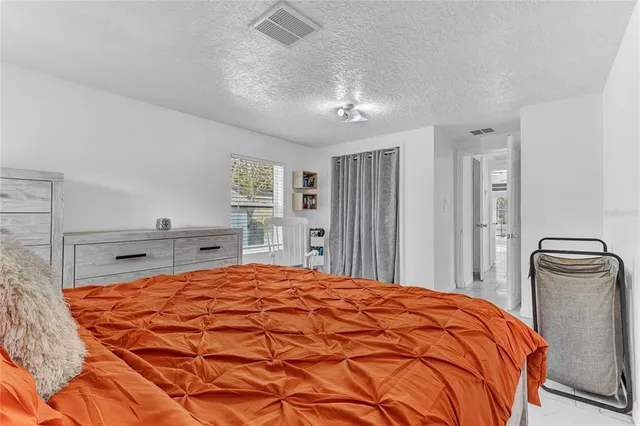 a bedroom with a bed and a closet